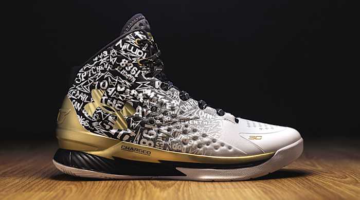 Side view of Stephen Curry's white, black, and gold Under Armour shoe.